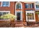 Inviting front entrance with black door and classic brick porch at 514 Lovinggood Ct, Woodstock, GA 30189