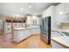 Well-lit kitchen with white cabinets, stainless steel appliances, and hardwood floors at 514 Lovinggood Ct, Woodstock, GA 30189