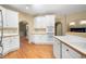 White kitchen with lots of cabinets and hardwood floors at 514 Lovinggood Ct, Woodstock, GA 30189
