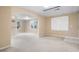 Large living room area showcasing neutral carpet, large windows, and an arched entryway at 514 Lovinggood Ct, Woodstock, GA 30189