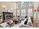 Bright living room featuring a fireplace, high ceilings, and large windows with natural light at 514 Lovinggood Ct, Woodstock, GA 30189