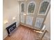 Cozy living room with a fireplace, hardwood floors, and tall windows at 514 Lovinggood Ct, Woodstock, GA 30189