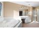 Lovely bathroom with a soaking tub, vanity, and separate glass enclosed shower at 514 Lovinggood Ct, Woodstock, GA 30189