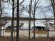 A waterfront view with boat docks surrounded by trees, showcasing the lake community at 514 Lovinggood Ct, Woodstock, GA 30189