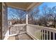 Open-air balcony featuring grey flooring, white railing with view of trees and neighboring homes at 2629 Apple Valley Ne Rd, Brookhaven, GA 30319