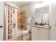 Cozy bathroom featuring a shower-tub, vanity with granite countertop, and neutral color palette at 2629 Apple Valley Ne Rd, Brookhaven, GA 30319