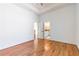 Bright bedroom with hardwood floors and a tray ceiling with an open door to the bathroom at 2629 Apple Valley Ne Rd, Brookhaven, GA 30319