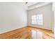 Bedroom featuring hardwood floors, ceiling fan, and a large window with blinds at 2629 Apple Valley Ne Rd, Brookhaven, GA 30319