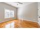 Bedroom with large window with blinds, hardwood floors and ceiling fan at 2629 Apple Valley Ne Rd, Brookhaven, GA 30319