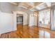 Bright dining room featuring hardwood floors, coffered ceilings, and modern light fixture at 2629 Apple Valley Ne Rd, Brookhaven, GA 30319