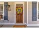 Elegant front door with a decorative wreath, flanked by stylish shutters and sconce lighting at 2629 Apple Valley Ne Rd, Brookhaven, GA 30319