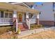 Inviting front porch with brick accents and white columns provides a charming entrance to the home at 2629 Apple Valley Ne Rd, Brookhaven, GA 30319