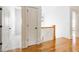 Bright hallway with hardwood floors, white walls and trim, and doorway leading to tiled room at 2629 Apple Valley Ne Rd, Brookhaven, GA 30319