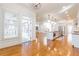 Open-concept kitchen with hardwood floors, white cabinetry, stainless steel appliances, and an island at 2629 Apple Valley Ne Rd, Brookhaven, GA 30319