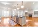 Open kitchen with island, stainless steel appliances, and pendant lighting with views into living room at 2629 Apple Valley Ne Rd, Brookhaven, GA 30319