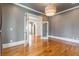 Hardwood floors, modern lighting, and classic trim accent the living room with gray colored walls at 2629 Apple Valley Ne Rd, Brookhaven, GA 30319