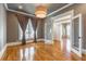 Bright and airy living room with hardwood floors, elegant lighting, and stylish gray walls at 2629 Apple Valley Ne Rd, Brookhaven, GA 30319