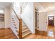 Elegant staircase with hardwood steps, white risers, and decorative railing leading to the upstairs at 2629 Apple Valley Ne Rd, Brookhaven, GA 30319