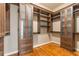 Organized walk-in closet with custom wood shelving and cabinets for ample storage space at 2629 Apple Valley Ne Rd, Brookhaven, GA 30319