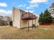 Beige vinyl sided house with a wooden deck with iron supports and a view of the backyard at 3519 Cast Palm Dr, Buford, GA 30519