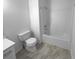 Updated bathroom featuring a tub-shower combination and toilet; new marble-look tile flooring at 3519 Cast Palm Dr, Buford, GA 30519