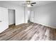 Bedroom features modern ceiling fan, wood flooring, and a closet for optimal storage at 3519 Cast Palm Dr, Buford, GA 30519