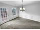 Dining area with modern chandelier, neutral tones, and door to outdoor patio at 3519 Cast Palm Dr, Buford, GA 30519