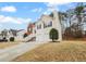 Exterior view of a two-story home featuring a two-car garage and a well-maintained lawn in a suburban setting at 3519 Cast Palm Dr, Buford, GA 30519