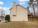 Beige vinyl sided house with a chimney and a wooden deck with iron supports at 3519 Cast Palm Dr, Buford, GA 30519