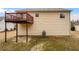 Beige vinyl sided house with a wooden deck with iron supports, an a/c unit, and landscaping at 3519 Cast Palm Dr, Buford, GA 30519