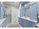 Elegant bathroom with blue cabinets, marble countertops, and glass-enclosed shower at 4740 Cypress Commons, Atlanta, GA 30338