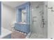 Elegant bathroom with blue vanity, glass shower, and luxurious tile at 4740 Cypress Commons, Atlanta, GA 30338