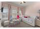 Charming pink bedroom featuring a daybed, large windows, and soft decor at 4740 Cypress Commons, Atlanta, GA 30338