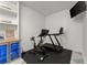 Home gym featuring a treadmill, stationary bike, storage shelves, and built-in beverage cooler at 4740 Cypress Commons, Atlanta, GA 30338