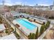 Community pool surrounded by well-maintained landscaping and brick buildings in a residential area at 4740 Cypress Commons, Atlanta, GA 30338