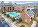 Aerial view of a community pool surrounded by trees and townhomes on a sunny day at 4740 Cypress Commons, Atlanta, GA 30338