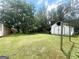 Spacious backyard featuring a storage shed and a grassy lawn, surrounded by mature trees at 961 Kingston Nw Rd, Conyers, GA 30012