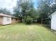 Spacious backyard featuring a well-maintained lawn, large shade trees, and an open area for recreation at 961 Kingston Nw Rd, Conyers, GA 30012