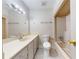 Bright bathroom featuring a single sink vanity, toilet, and combined shower and tub with neutral tile at 961 Kingston Nw Rd, Conyers, GA 30012