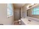 Clean bathroom featuring a shower, vanity, and ample natural light at 961 Kingston Nw Rd, Conyers, GA 30012