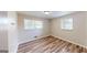 Bright bedroom featuring updated flooring, and two windows at 961 Kingston Nw Rd, Conyers, GA 30012