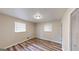 Cozy bedroom with updated flooring, a closet, and natural light from two windows at 961 Kingston Nw Rd, Conyers, GA 30012