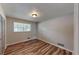 Bedroom with hardwood floors, window, closet, and a ceiling light at 961 Kingston Nw Rd, Conyers, GA 30012