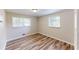 Bedroom with hardwood floors and two windows at 961 Kingston Nw Rd, Conyers, GA 30012