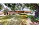 Charming brick home with a well-maintained lawn and mature trees at 961 Kingston Nw Rd, Conyers, GA 30012