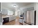 Well-lit kitchen features stainless steel appliances, ample counter space, and tile flooring at 961 Kingston Nw Rd, Conyers, GA 30012