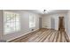 Cozy living room with bright windows and wood-look floors at 961 Kingston Nw Rd, Conyers, GA 30012