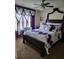 Bedroom featuring purple and white bedding, butterfly accents and decorative window treatments at 2761 Trebek Ct, Mcdonough, GA 30253