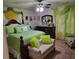 Bright bedroom with green and yellow bedding, decorative pillows, and sitting bench at 2761 Trebek Ct, Mcdonough, GA 30253