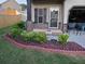 Landscaped front yard with shrubs, mulch, and decorative red stone accents at 2761 Trebek Ct, Mcdonough, GA 30253